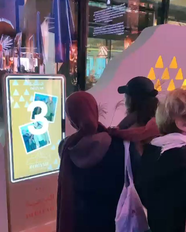Three guests pose as FRXME counts down to their photo at Outernet London.