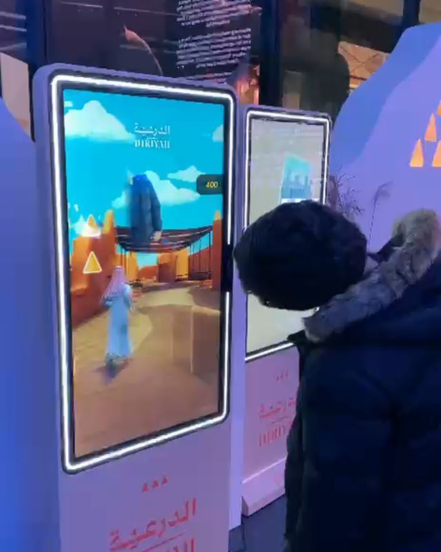 A boy plays Diriyah’s AR game on FRXME at Outernet London.
